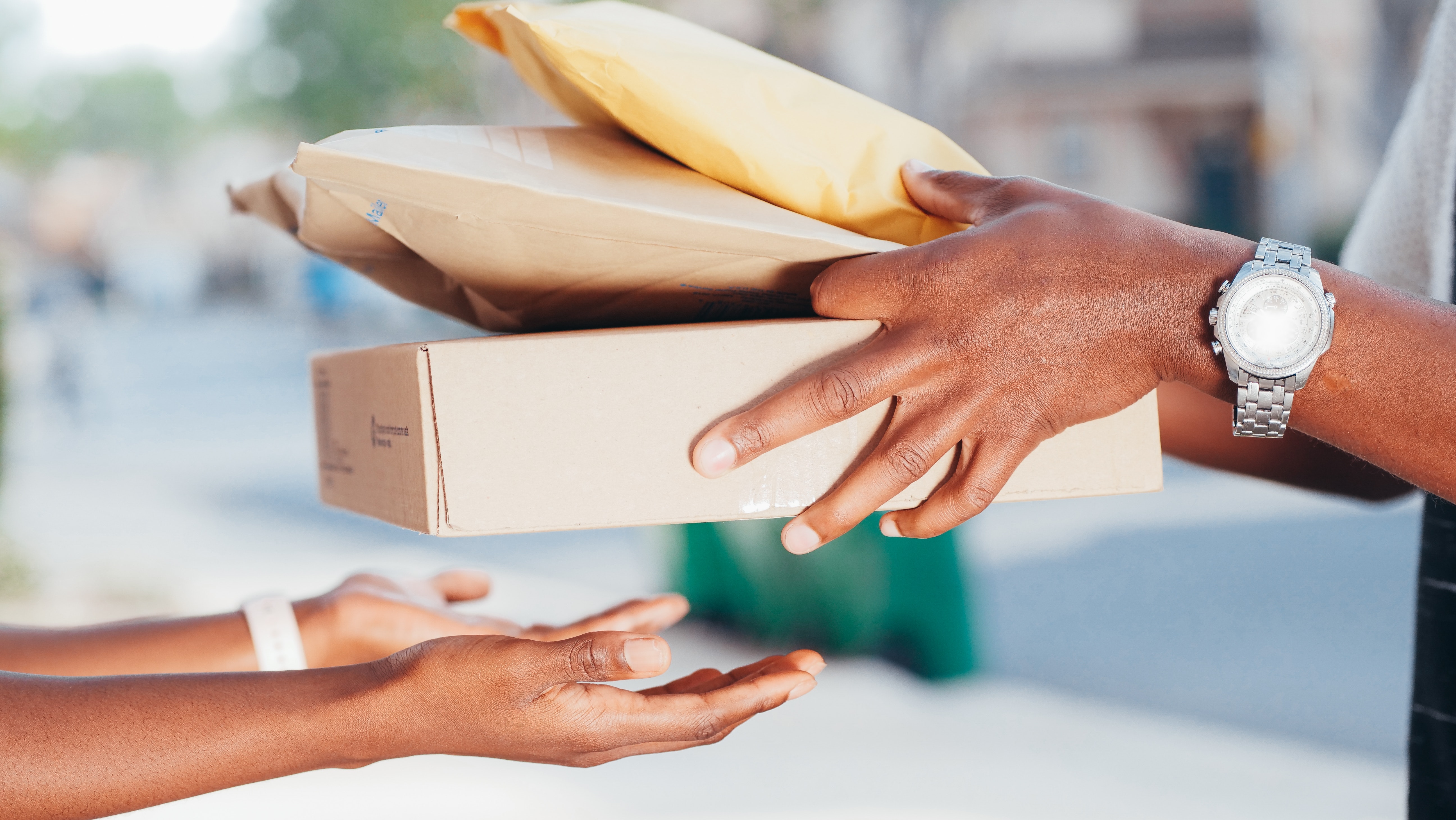 parcel courier hands over packages to customer